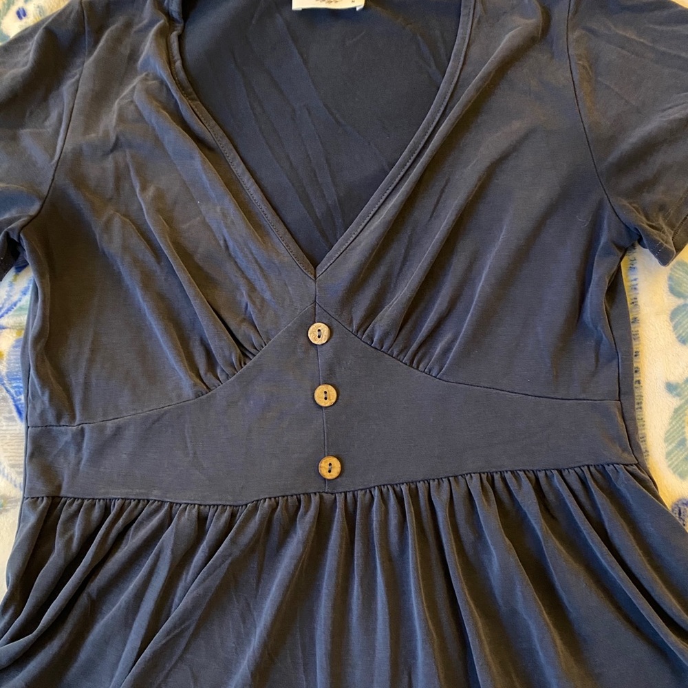 Beautiful, slate blue slight peplum button top